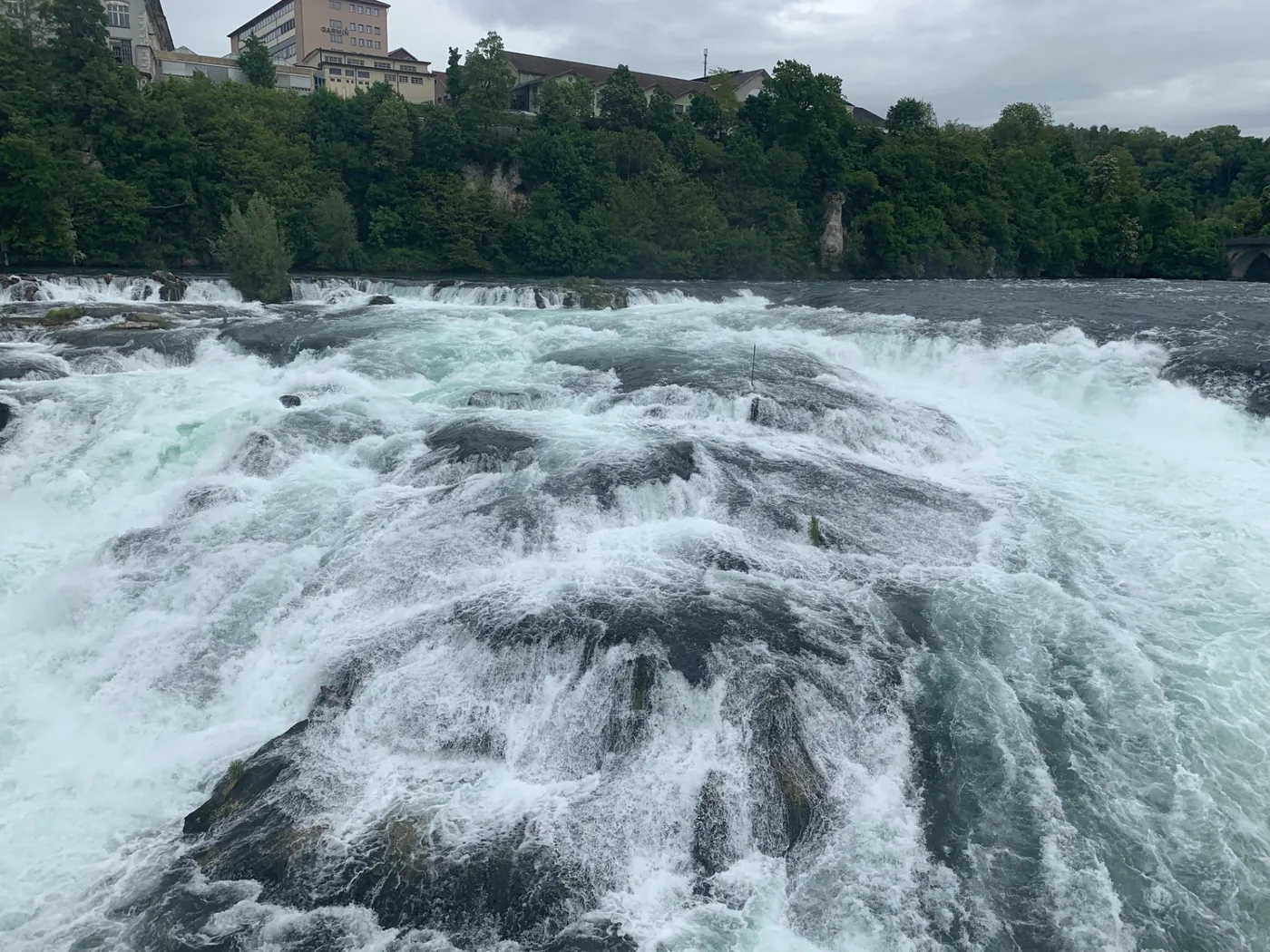 Close-up of churning white water pouring over the river rocks of the Rhine