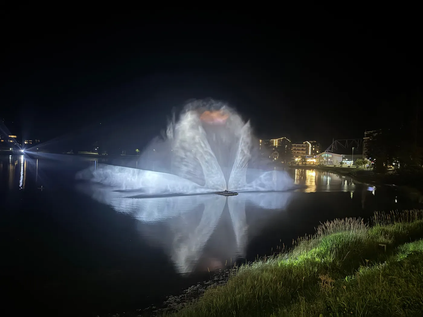 The AquaLumina water-and-light show lit up on the dark Obersee in Arosa