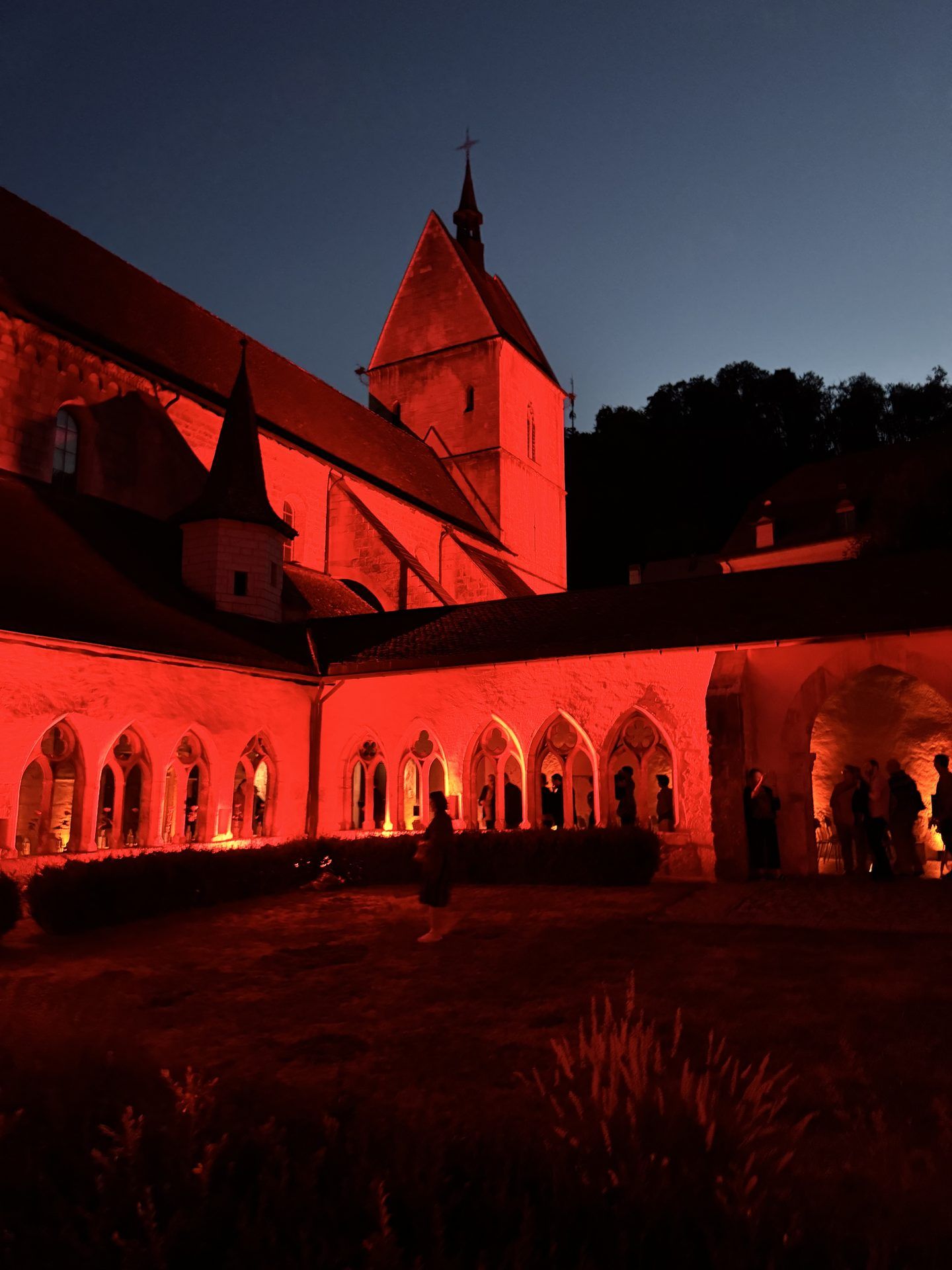 The collegiate church and cloister of Saint-Ursanne, floodlit at dusk