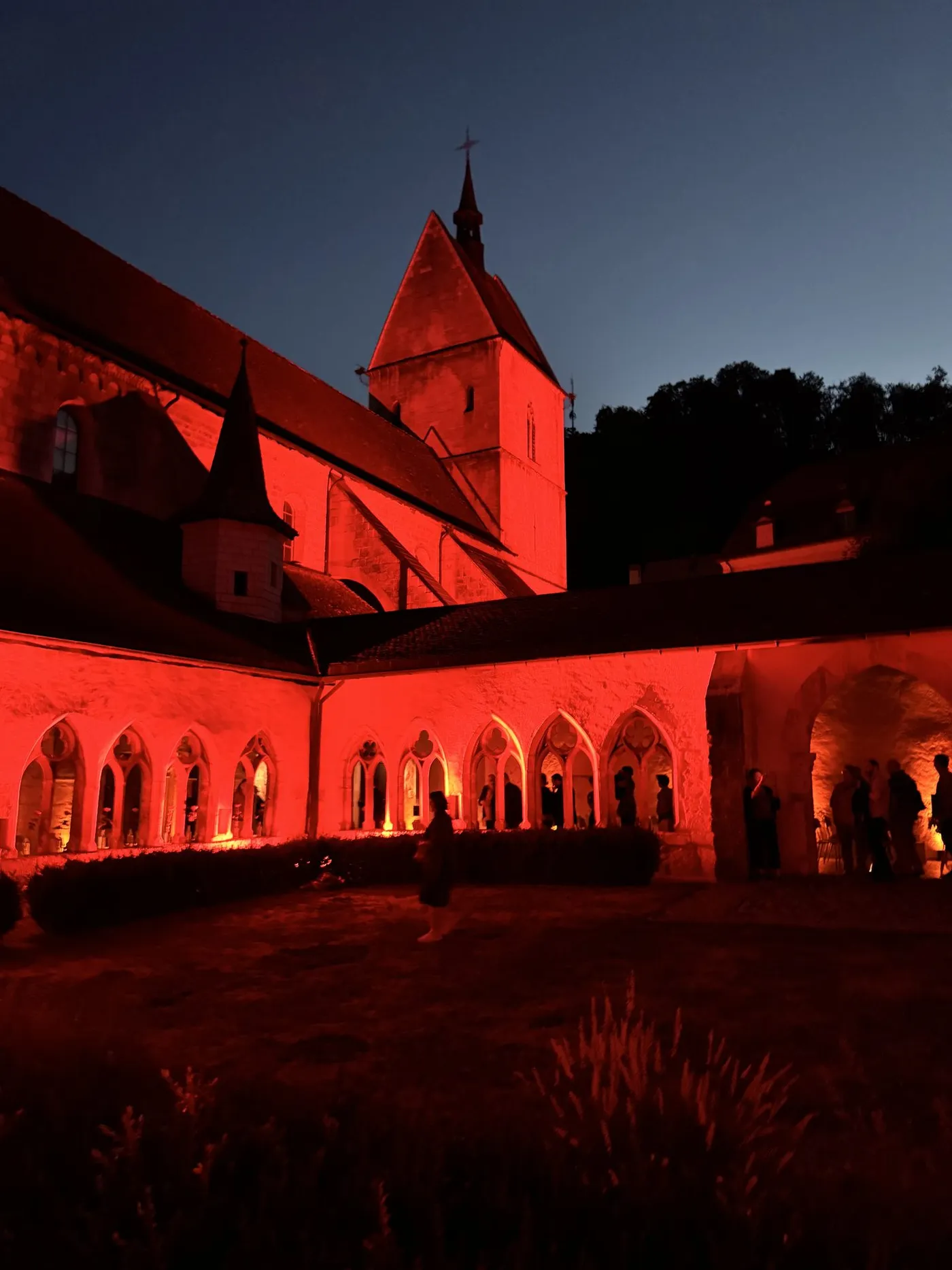 The collegiate church and cloister of Saint-Ursanne, floodlit at dusk